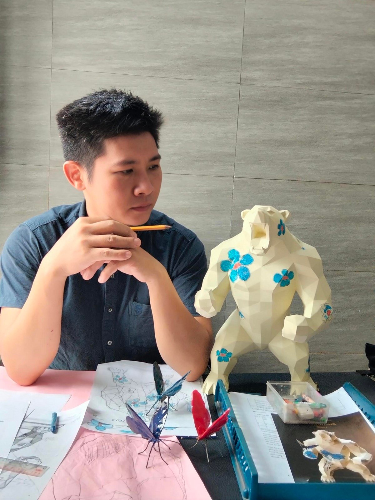 Vo Anh Tuan working with a Young King sculpture from The Young King Universe